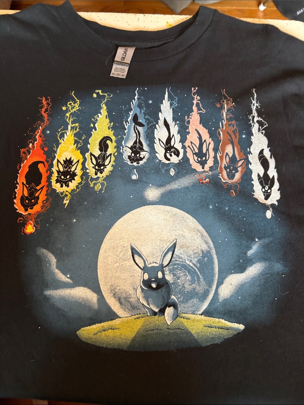 Men’s Pokémon Evolutionary Comets. Black Graphic Eevee & Evolutions Tee